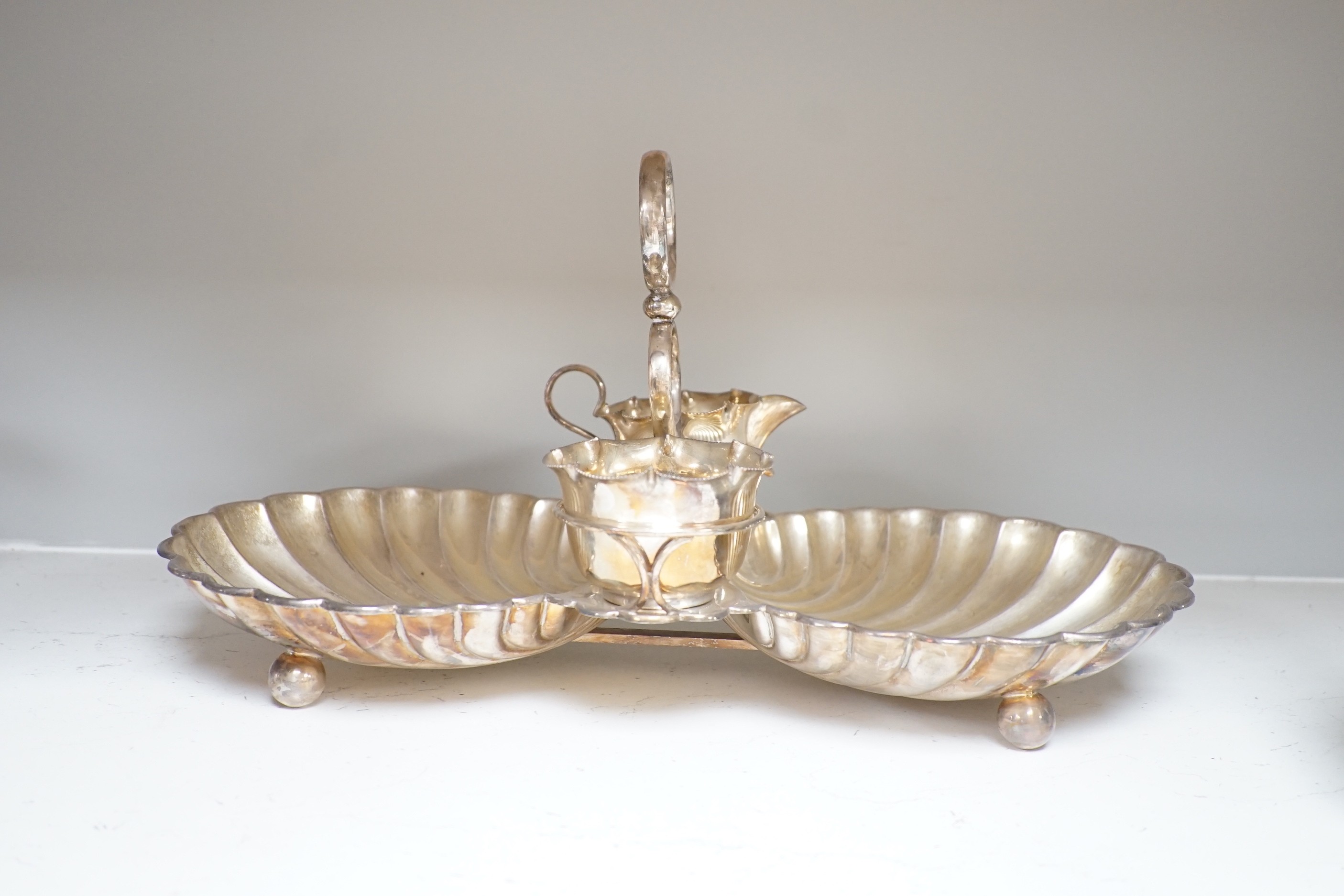 A silver plated strawberry and cream stand with a silver mounted coaster, and a plated biscuit barrel